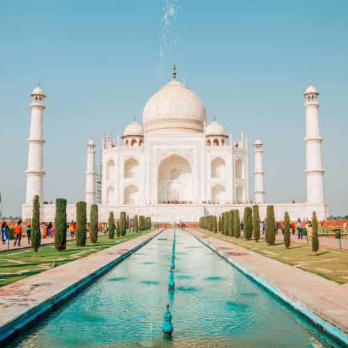 El Taj Mahal con su fuente central reflejando su belleza, un emblema de los viajes a la India