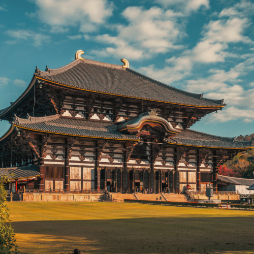 Fotografía del Templo Todai-ji en Nara, Japón, con cielo azul y césped verde.