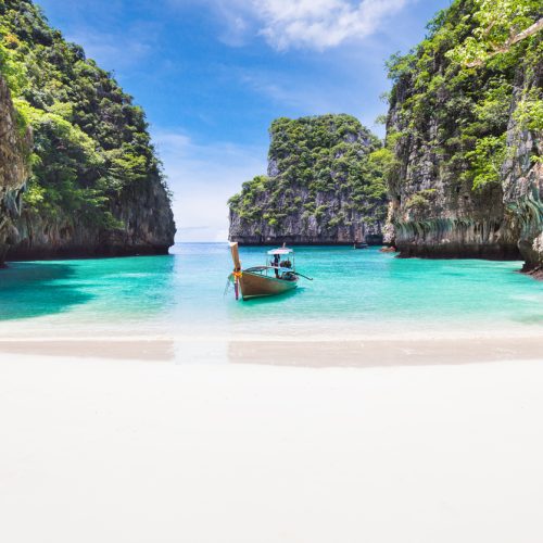 The Thai traditional wooden longtail boat and beautiful beach in Phuket province, Thailand.